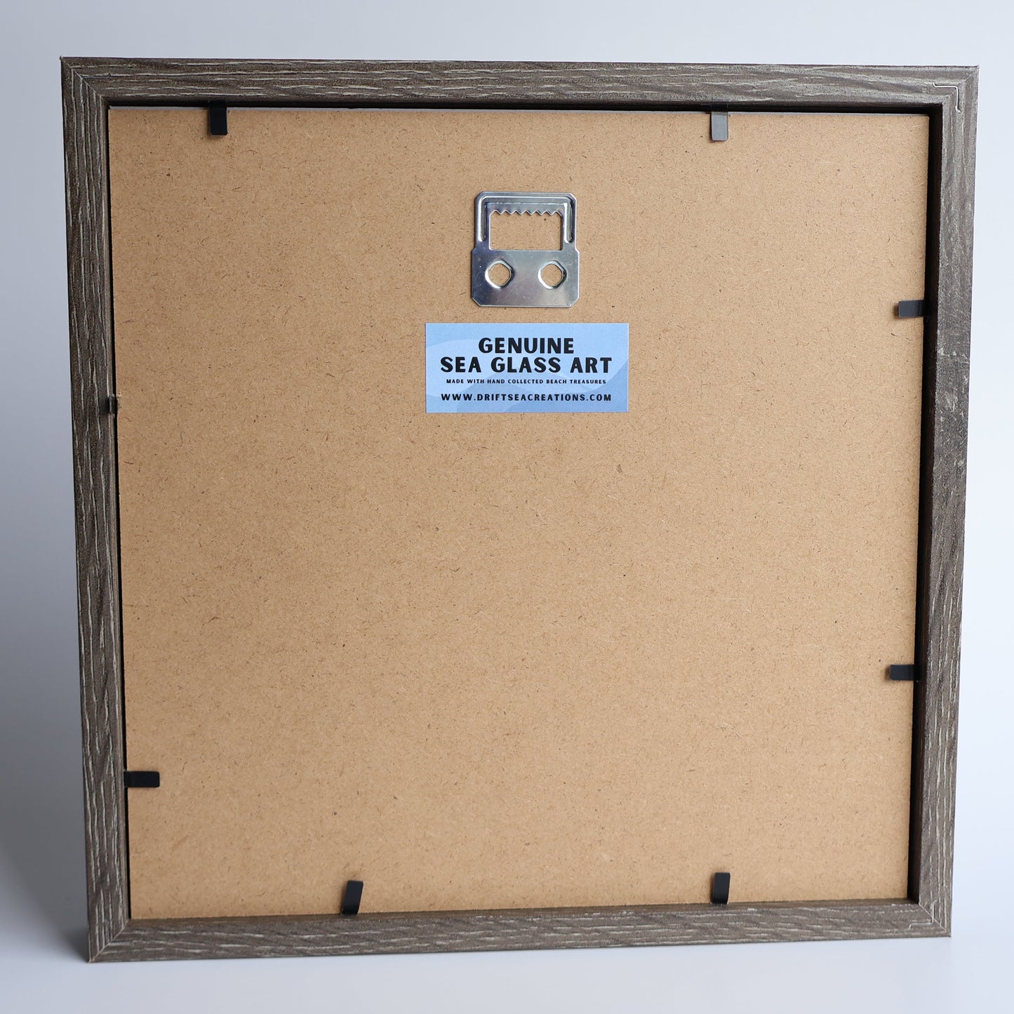 Framed artwork with a visible brand label on a white background