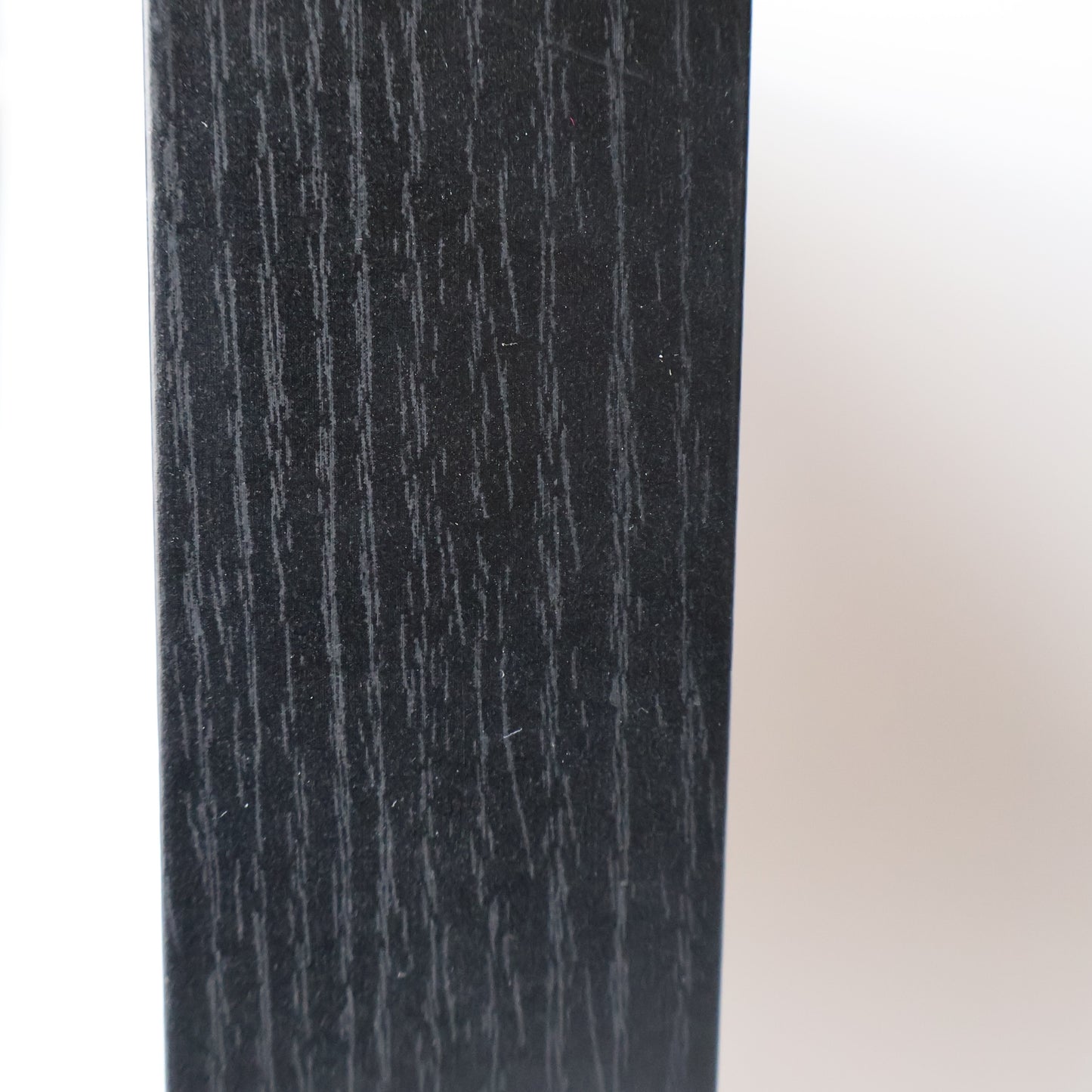 Close-up of a textured black surface with a white background